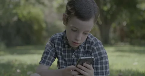 Young boy playing with a smartphone Stock-Footage 55331341
