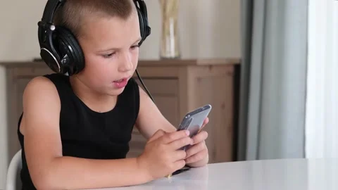 Young boy playing in smartphone. Video stock 158616230