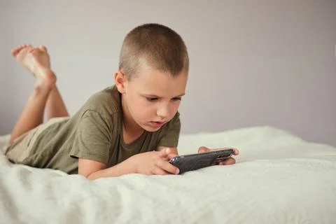 Young boy playing in smartphone. Stock Photos