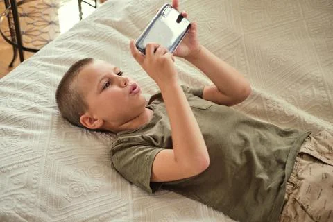 Young boy playing in smartphone. Stock Photos