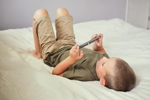 Young boy playing in smartphone. Stock Photos