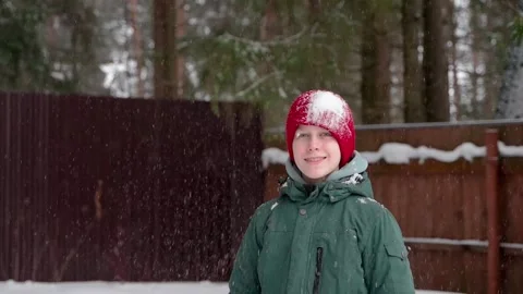 Young boy playing with snow and smiling Stock Footage 265791345