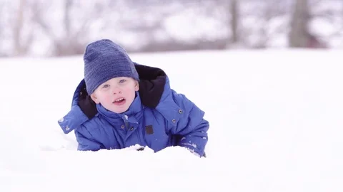 Young boy playing in the snow Stock-Footage 80127726