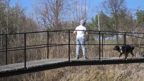 Young Boy Playing with Soap Bubbles on a Wooden Footbridge in Spring Nature Stock Footage 342230965