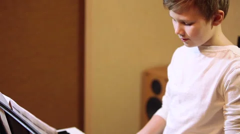 Young boy playing on a synthesizer Video stock 60224076