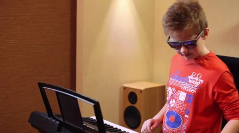Young boy playing on a synthesizer Stock Footage 60224575