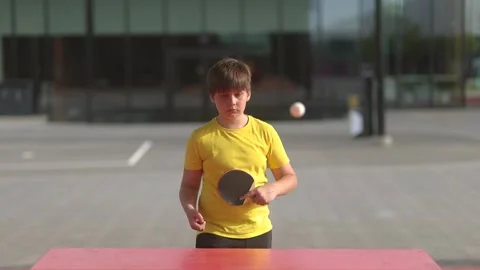 Young Boy Playing Table Tennis - 4K Outdoor Stock Footage 336274574