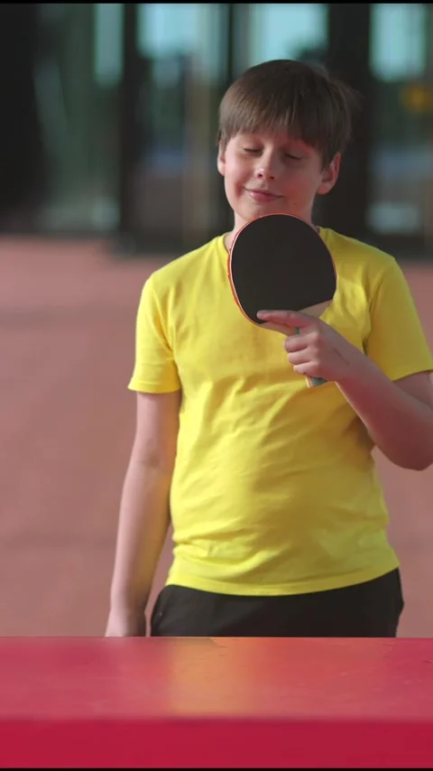 Young boy playing table tennis outdoors, vertical video Stock Footage 336307628