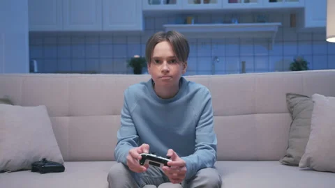 Young Boy Playing Video Console with Gamepad Joystick Controller and Losing Game Stock Footage 225417171