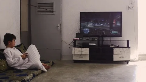 Young boy playing a video game at home in northern Iraq Stock Footage 72326203