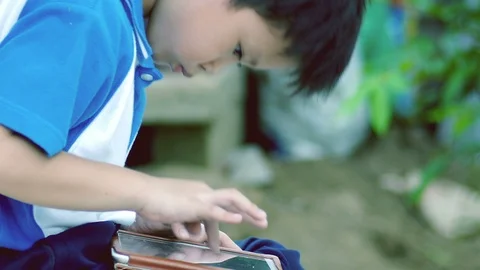 Young Boy Playing Video Game On The Tablet Stock Footage 99067366