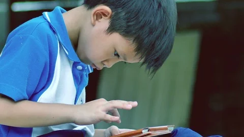 Young Boy Playing Video Game On The Tablet Stock Footage 99067574