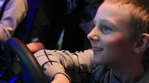 Young  boy playing video games at indoor amusement park. Stock Footage 64819829