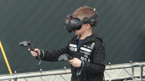 Young boy playing with virtual reality glasses and joysticks Stock-Footage 104098519