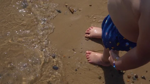 Young boy playing in the water at the beach Stock Footage 115958245
