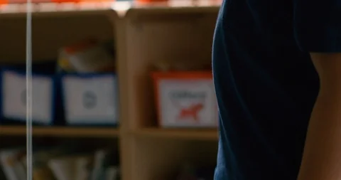 Young boy playing with a yo-yo in a classroom Stock Footage 108783687
