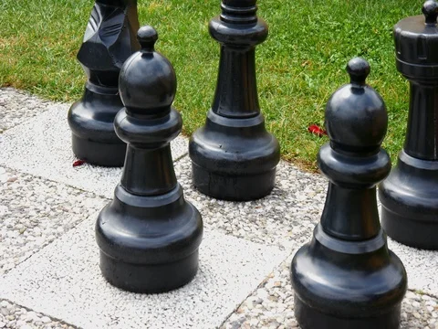 Young boy plays in big chess 4 Stock Footage 78356871