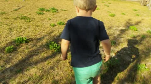 Young boy plays chase 2 - slow motion Stock Footage 22346456