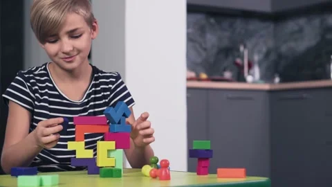 Young boy plays with colourful blocks, slow motion. Stock Footage 165279005