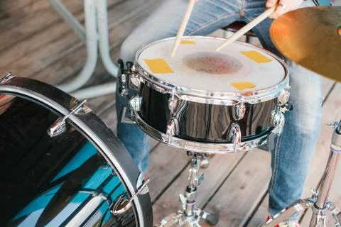 A young boy plays on a drum Stock Photos