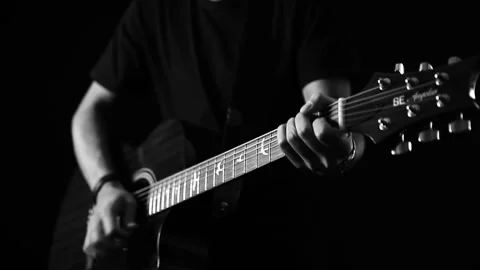A young boy plays a guitar Stock Footage 145509712