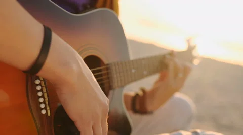 Young boy plays guitar at sunset Stock Footage 63536689