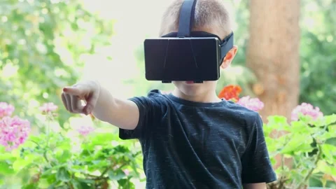 Young boy plays having fun with a 3d mask Stock Footage 136023297