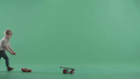 Young boy plays with his remote controlled toy car Stock Footage 77780706