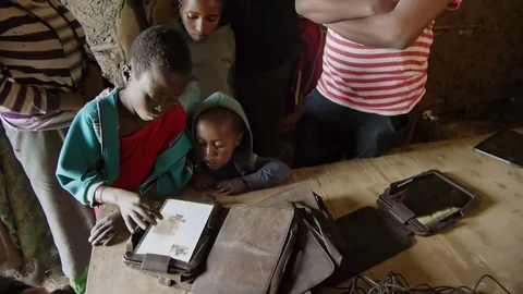 A young boy plays on his tablet computer in a rural place in Ethiopia Vidéo 75005352