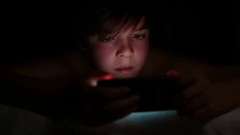 Young boy plays online on his smartphone Video stock 77716675