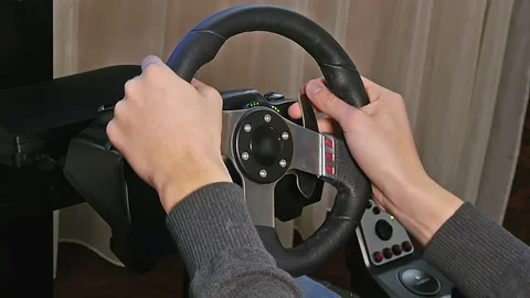 Young boy plays a virtual racing video game Stock Footage 69963753