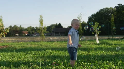 Young Boy Poke Bubbles - 4k - Slow motion Stock Footage 61109345