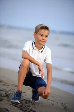 Young boy posing at the beach. Cute smiling happy 11 years old boy at seaside Stock Photos