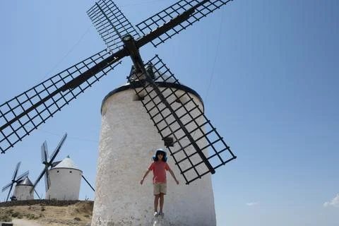 Young boy posing in front of Consuegra windmills in Castilla La Mancha, Spain Stock Photos