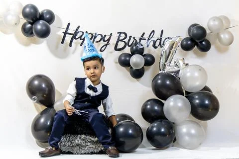 Young Boy Posing With Party Hat At Stylish Indoor Birthday Celebration Stock Photos