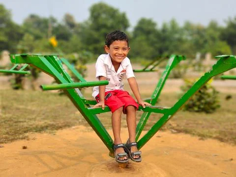 Young boy posing in summer park with green blur background. Cute smiling 5 years 스톡 사진