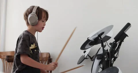 Young boy practice playing electronic instrument drums at living room at home Stock Footage 209875276