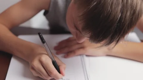 Young boy practicing cursive handwriting showcases diligence and focus whil.. Stock Footage 294549750
