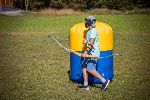 Young boy preparing to shoot arrow during a game of archery tag Stock Photos