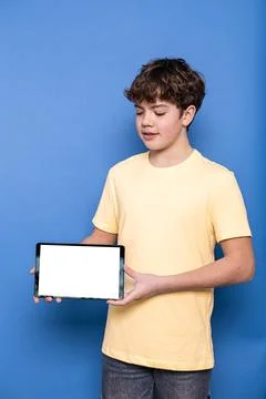 Young boy presenting blank digital tablet screen Foto stock