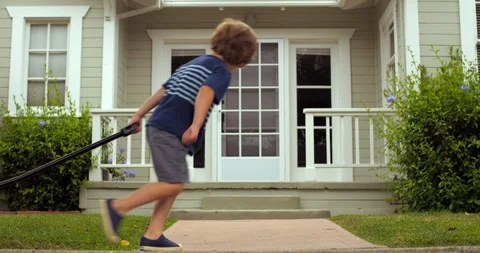 Young boy pulling his baby brother along in a cart Vidéo 88372556