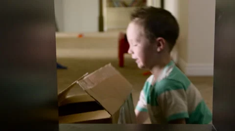 Young boy pulls off box from shelf and dumps blocks Stock Footage 62776358