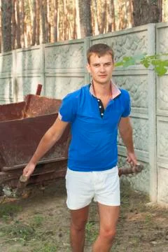A young boy pulls cart before Stock Photos