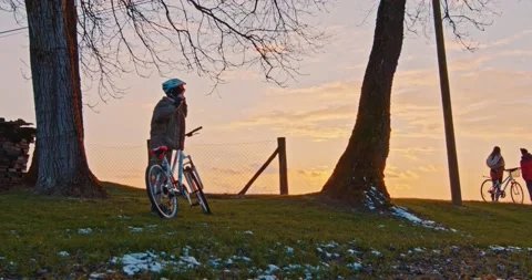 The young boy puts on his helmet before cycling in nature - slow motion Stock Footage 146743397