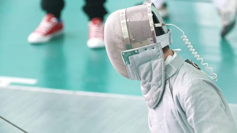 Young boy with rapier in protective mask in a fencing tournament Stock Footage 87708187