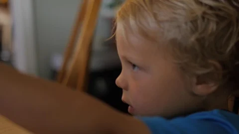 Young boy reaches up on table grabs a chip and eats it Stock-Footage 121404933