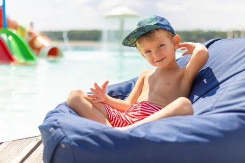 Young Boy Relaxing by the Poolside Stock Photos