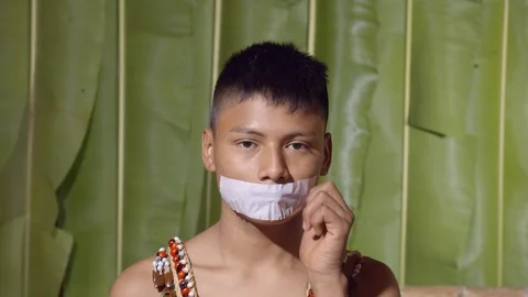 Young boy remove adhesive tape covering the mouth like it won't be quiet anymore Stock Footage 113217270