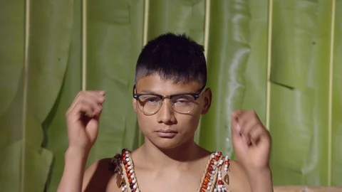 Young boy removing the eye glasses like done reading or no need for them in Stock Footage 113217092