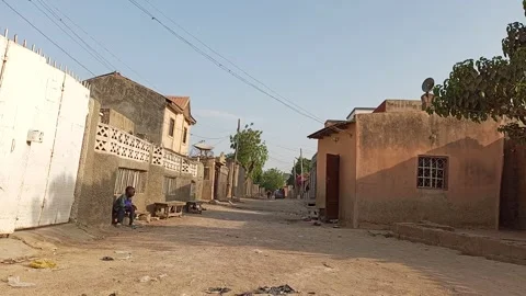 Young Boy Resting By Street Side With Pedestrians Kano Nigeria 動画素材 331070554